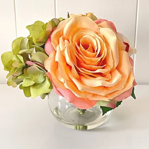 A picture of mixed soft-colored roses, peonies, and green hydrangeas.