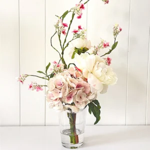 A picture of a pink hydrangea and cream peony.