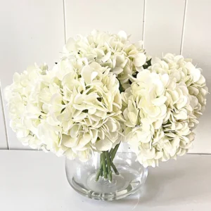 A picture of a white artificial hydrangea silk flower.