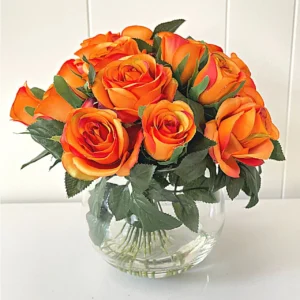 A picture of an orange rose bouquet in a glass vase.