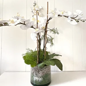 A picture of a white orchard artificial flower in a pot.